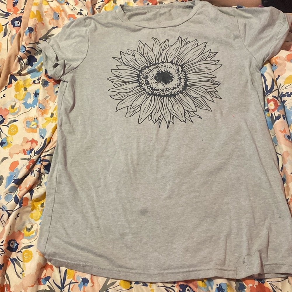 A sunflower shirt that is black and gray